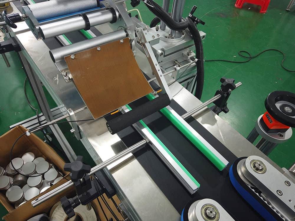 Top labeling mechanism for labeling machines